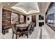 Game room with an oval table, dark wood chairs, and stone wall at 6308 Woodlake Dr, Buford, GA 30518