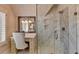 Bathroom boasts a vanity, glass shower, and marble tile at 6308 Woodlake Dr, Buford, GA 30518