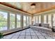 Sunroom with serene lake views and comfortable seating at 6308 Woodlake Dr, Buford, GA 30518