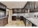 Dark wood cabinetry, granite counters, and stainless steel appliances at 6308 Woodlake Dr, Buford, GA 30518