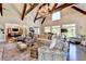 Spacious living room with high ceilings, exposed beams, and a cozy fireplace at 6308 Woodlake Dr, Buford, GA 30518