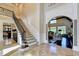 Grand entryway with tile flooring, staircase, and views to the living room at 6308 Woodlake Dr, Buford, GA 30518