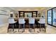 Basement bar with seating and views to the backyard and pool at 6308 Woodlake Dr, Buford, GA 30518