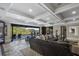 Open-concept basement with sliding doors leading to a patio and lake view at 6308 Woodlake Dr, Buford, GA 30518