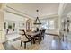 Formal dining room featuring a large table, chandelier, and hardwood floors at 6308 Woodlake Dr, Buford, GA 30518