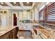 Kitchen features a copper farm sink, custom cabinetry and hardwood floors at 6308 Woodlake Dr, Buford, GA 30518