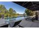 Luxury pool with lake view and plenty of lounge chairs at 6308 Woodlake Dr, Buford, GA 30518