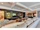 Finished basement with large sectional sofa, built-in entertainment center, and wet bar at 6308 Woodlake Dr, Buford, GA 30518
