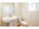 Small powder room with pedestal sink and toilet at 7530 Homer Dr, Cumming, GA 30028