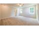 Large main bedroom with ceiling fan and carpet at 7530 Homer Dr, Cumming, GA 30028