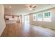 Large living room with hardwood floors, kitchen and backyard access at 7530 Homer Dr, Cumming, GA 30028