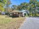 White house with wooden porch and surrounding trees at 3534 Dahlonega Hwy, Cumming, GA 30028