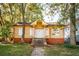 Charming yellow house with a front porch and steps at 418 N Highland Ne Ave, Atlanta, GA 30307