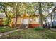A charming yellow bungalow with boarded-up windows sits on a tree-lined lot at 418 N Highland Ne Ave, Atlanta, GA 30307