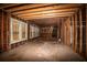 A fixer-upper home's interior, gutted and awaiting renovation, reveals exposed wood beams and framing at 418 N Highland Ne Ave, Atlanta, GA 30307