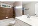 Bathroom with white vanity, brown tile, and bathtub at 1712 Country Wood Dr, Hoschton, GA 30548
