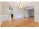 Spacious dining room, hardwood floors, chandelier, and views to kitchen at 1712 Country Wood Dr, Hoschton, GA 30548