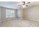 Bright and airy bedroom with large window and ceiling fan at 1712 Country Wood Dr, Hoschton, GA 30548