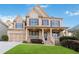 Brick house with a large front yard and a three-car garage at 1712 Country Wood Dr, Hoschton, GA 30548