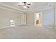 Main bedroom with trey ceiling and carpet flooring at 1712 Country Wood Dr, Hoschton, GA 30548