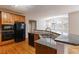 Kitchen with large island, granite countertops, and stainless steel appliances at 1712 Country Wood Dr, Hoschton, GA 30548