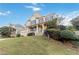 Brick house with a large front yard and a three-car garage at 1712 Country Wood Dr, Hoschton, GA 30548