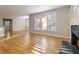 Living room with hardwood floors, fireplace, and ample natural light at 1712 Country Wood Dr, Hoschton, GA 30548