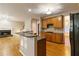 Kitchen with an island, wooden cabinetry, and granite countertops at 1712 Country Wood Dr, Hoschton, GA 30548