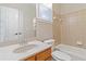 Bathroom with tub, shower, and wood vanity at 1712 Country Wood Dr, Hoschton, GA 30548