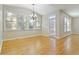 Breakfast area with hardwood floors, chandelier and multiple windows at 1712 Country Wood Dr, Hoschton, GA 30548