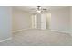 Spacious bedroom with ceiling fan and neutral-toned carpet at 1712 Country Wood Dr, Hoschton, GA 30548