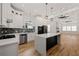 Open concept kitchen with white cabinets, blue tile backsplash, stainless steel appliances and an island at 865 Mcdaniel Sw St, Atlanta, GA 30310