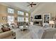 Two-story Gathering room with a stone fireplace and built-in shelving at 1719 Cat Tail Ct, Lawrenceville, GA 30044