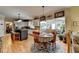 Kitchen with island, sunroom view, and hardwood floors at 1719 Cat Tail Ct, Lawrenceville, GA 30044