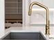 Modern kitchen sink with gold faucet and marble countertop at 1413 Windsor Ne Pkwy, Brookhaven, GA 30319