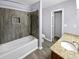 Modern bathroom with tile shower, tub, and granite vanity at 1002 Cumberland Se Ct, Smyrna, GA 30080