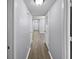 Long hallway with wood-look floors and neutral walls at 1002 Cumberland Se Ct, Smyrna, GA 30080