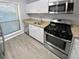 Modern kitchen with stainless steel appliances and granite countertops at 1002 Cumberland Se Ct, Smyrna, GA 30080