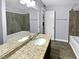 Updated bathroom with granite vanity and tile shower/tub combo at 1002 Cumberland Se Ct, Smyrna, GA 30080
