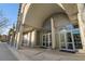 Modern building exterior featuring an arched entryway and glass doors at 361 17Th Nw St # 1001, Atlanta, GA 30363
