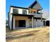 Rear view of the home showcasing a balcony and covered patio at 159 Shadburn Ferry Rd, Buford, GA 30518