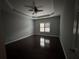 Spacious bedroom with dark hardwood floors, ceiling fan, and window with shutters at 2905 Windsong Park Ln, Dacula, GA 30019