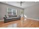 Bright living room with hardwood floors, neutral walls, and a comfy sofa at 1825 Center Ave, Atlanta, GA 30344