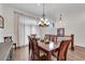 Bright dining room features a large wood table, chandelier, and hardwood floors at 3637 Habersham Nw Rd # 46, Atlanta, GA 30305