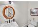 Small bathroom with white toilet and vanity, featuring an oval mirror at 3637 Habersham Nw Rd # 46, Atlanta, GA 30305
