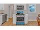 Modern kitchen with blue stove and white shaker cabinets at 369 Bell Se St, Marietta, GA 30060