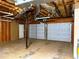 Unfinished three-car garage with an additional storage room at 413 Kenny Ln, Temple, GA 30179