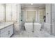 Luxurious bathroom with soaking tub, marble tile, and modern vanity at 940 Waters Reach Ct, Alpharetta, GA 30022