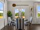 Charming dining area with striped chairs and view to backyard at 3856 Kastler Dr, South Fulton, GA 30349