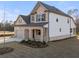 Two-story house with brick and white siding, landscaping, and a two-car garage at 3867 Kastler Dr, South Fulton, GA 30349